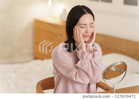 Woman doing skin care at night Woman doing skin care at night 127670471