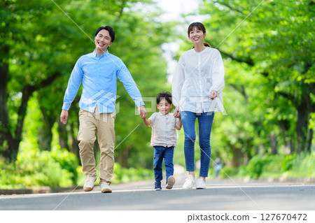 Families walking hand in hand Families walking hand in hand 127670472