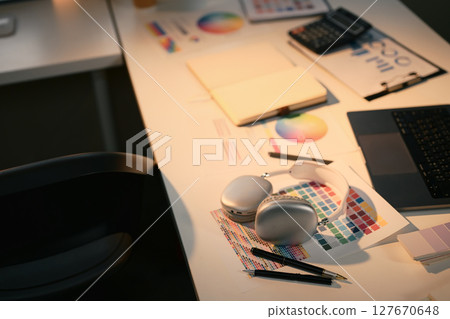 Modern graphic design workspace with color swatches, headphones, and digital tools Modern graphic design workspace with color swatches, headphones, and digital tools 127670648