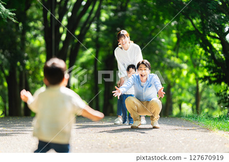 Boy running towards family Boy running towards family 127670919