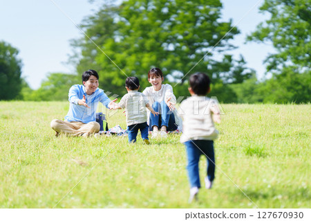 Boy running towards family Boy running towards family 127670930