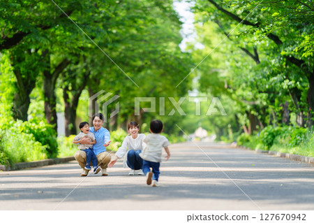 Boy running towards family Boy running towards family 127670942