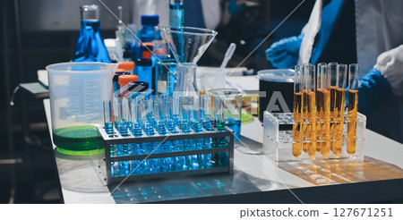 Scientist pipetting medical samples into microplate in laboratory Scientist pipetting medical samples into microplate in laboratory 127671251