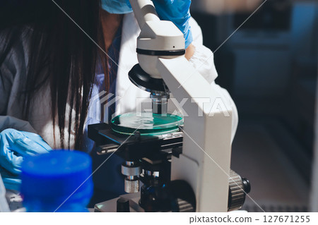 Scientist pipetting medical samples into microplate in laboratory Scientist pipetting medical samples into microplate in laboratory 127671255