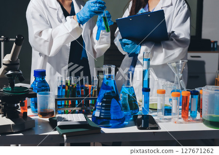 Scientist pipetting medical samples into microplate in laboratory Scientist pipetting medical samples into microplate in laboratory 127671262