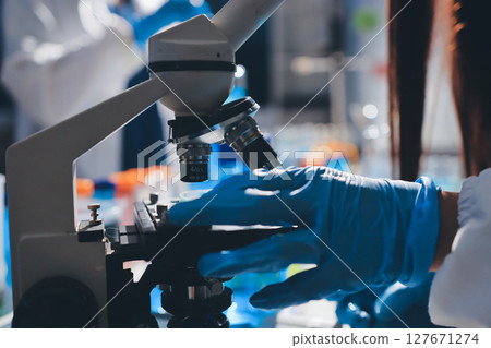 Scientist pipetting medical samples into microplate in laboratory Scientist pipetting medical samples into microplate in laboratory 127671274
