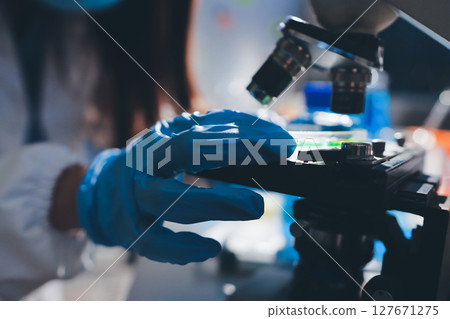 Scientist pipetting medical samples into microplate in laboratory Scientist pipetting medical samples into microplate in laboratory 127671275