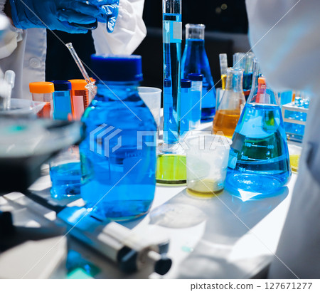 Scientist pipetting medical samples into microplate in laboratory 127671277