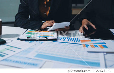 Two business people analyzing the data Two business people analyzing the data 127671289