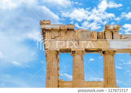 Parthenon pillars in front of blue and cloudy sky 127671517