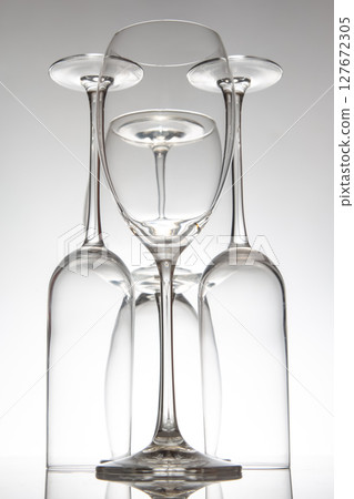 A sophisticated arrangement of five empty wine glasses with long stems, 127672305