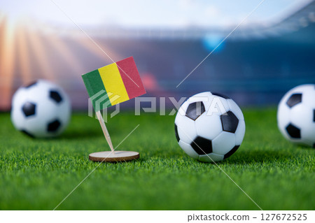 Mali national flag stands proudly on a vibrant green soccer fiel 127672525