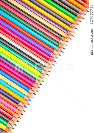 A close-up of colorful pencils in a row on a white surface A close-up of colorful pencils in a row on a white surface 127672732