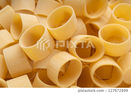 Raw Calamarata Big Pasta Isolated, Homemade Dry Macaroni, Italian Raw Round Noodle 127672899