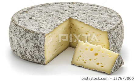 A large whole wheel of gourmet aged cheese with a slice cut out, showcasing a creamy texture and holes on a white background. 127673800
