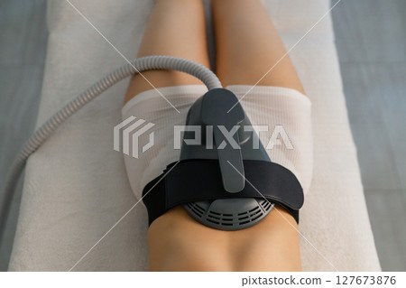 Woman getting treatment on buttocks to burn fat, build muscles and remove cellulite. Professional beauty salon Woman getting treatment on buttocks to burn fat, build muscles and remove cellulite. Professional beauty salon 127673876