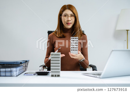 Home loan officer holding model home loan concept. 127673918