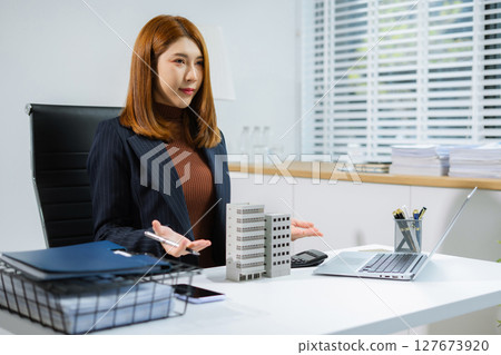 Home loan officer holding model home loan concept. Home loan officer holding model home loan concept. 127673920