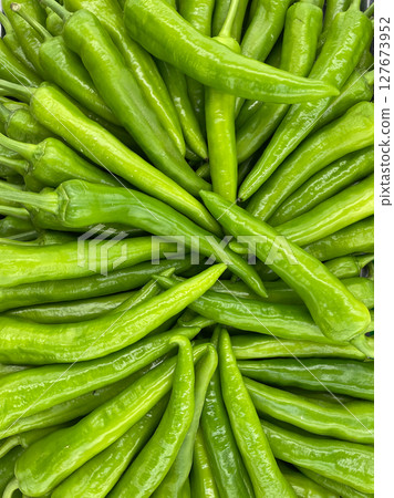 lots of hot chili peppers for food as background lots of hot chili peppers for food as background 127673952