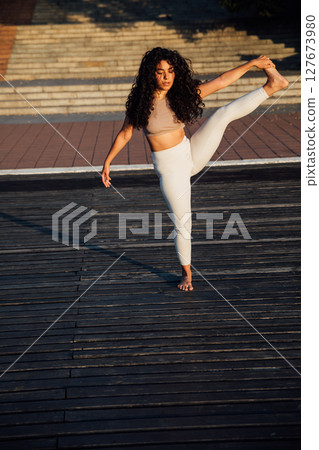 brunette woman doing gymnastics yoga asana 127673980