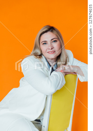 40 years old woman in white business suit at work 40 years old woman in white business suit at work 127674035
