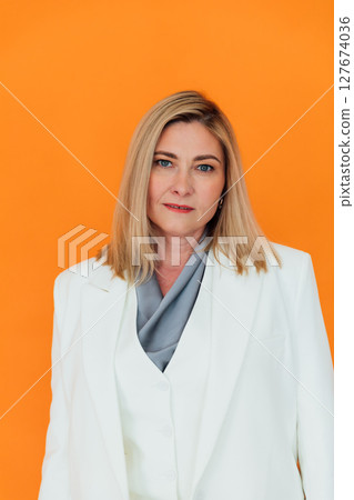 40 years old woman in white business suit at work 40 years old woman in white business suit at work 127674036