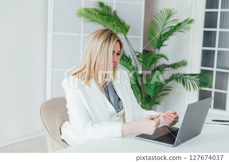 Woman in business working with laptop in office 127674037