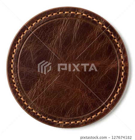 Empty brown leather label with stitching on a white background, top view, for branding and product design. 127674182