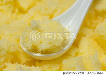 Natural Indian Traditional Ghee Butter Clarified Butter In Spoon Close-Up Natural Indian Traditional Ghee Butter Clarified Butter In Spoon Close-Up 127674661