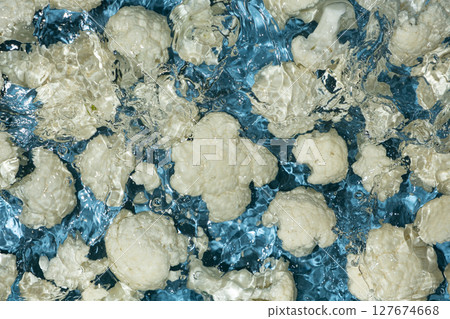Fresh Cauliflower Dropped in Water with Splash Effect Above. 127674668