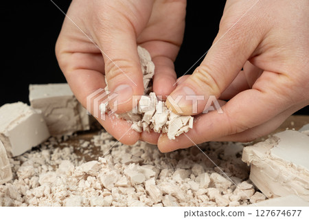 Crumbling Moist Yeast Block by Hand Close-Up. Crumbling Moist Yeast Block by Hand Close-Up. 127674677