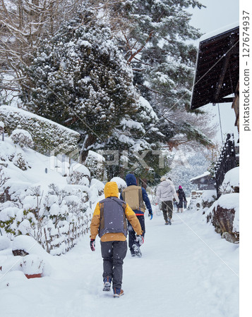 Snow-covered old townscape and tourists in Magome-juku, a tourist spot on the Nakasendo road in winter Snow-covered old townscape and tourists in Magome-juku, a tourist spot on the Nakasendo road in winter 127674937