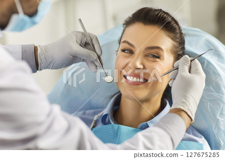 Dentist exam, teeth, gums, dental care exam, happy smiling woman healthy smile at doctor visit  127675285