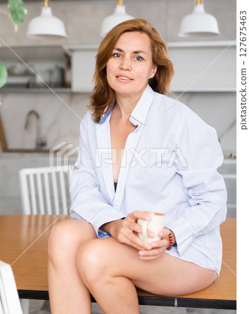 Nude adult woman in shirt posing in kitchen 127675463