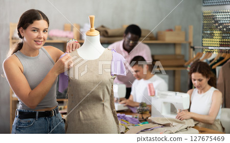 Young woman working with mannequin during dressmaking class Young woman working with mannequin during dressmaking class 127675469