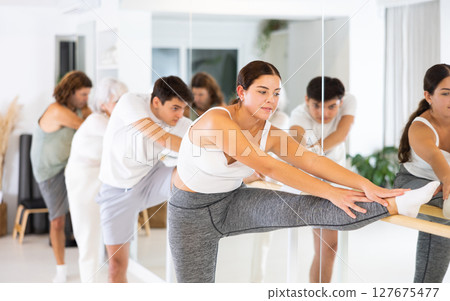 Young woman doing choreography at ballet barre 127675477