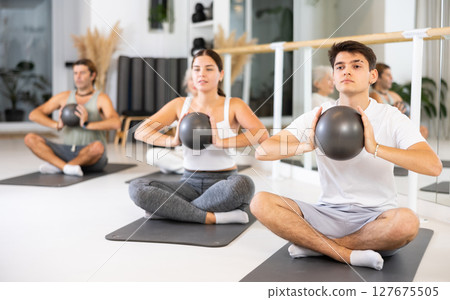 Group of different people doing exercises with ball 127675505