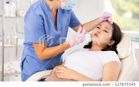 Doctor doing anti-aging beauty procedures Doctor doing anti-aging beauty procedures 127675545