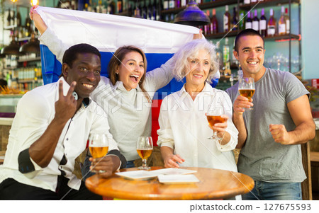 Diverse group celebrating with Russian flag 127675593