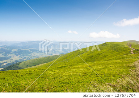 carpathian mountain landscape of ukraine in summer. transcarpathia weekend . wonderful nature scenery of alpine grassy meadow and green hills on a sunny day under blue sky. popular travel destination 127675704