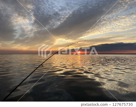 evening fishing in the sea from a boat, beautiful seascape 127675730