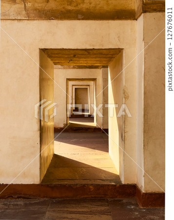 Ancient sandstone portal with arch, creating a passage through time. Symmetrical doorway, light and Ancient sandstone portal with arch, creating a passage through time. Symmetrical doorway, light and 127676011