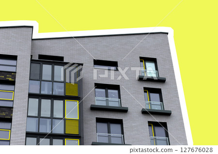Building corner with modern apartment architecture. Yellow facade with geometric windows and Building corner with modern apartment architecture. Yellow facade with geometric windows and 127676028