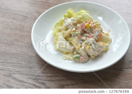 mashed tuna with corn and garden pea couple cabbage vegetable salad dressing cream sauce on plate 127676399