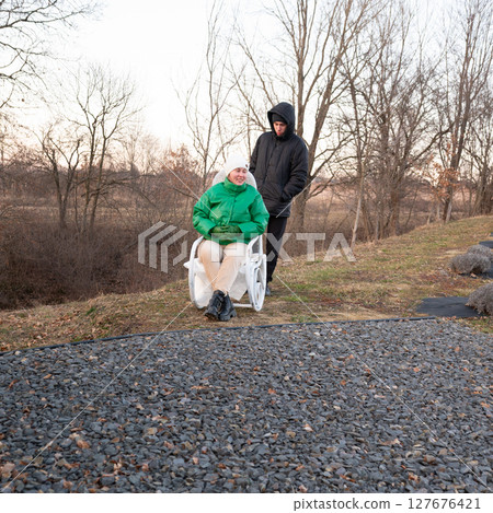 Joyful connection between friends during a winter outing by a serene riverside in the late afternoon sun with a touch of laughter and warmth 127676421