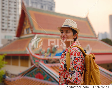 Woman Exploring Colorful Streets Near Buddhist Temples in Bangkok. Female traveler strolling through charming streets of Bangkok, surrounded by traditional architecture and beautiful Buddhist temples. Woman Exploring Colorful Streets Near Buddhist Temples in Bangkok. Female traveler strolling through charming streets of Bangkok, surrounded by traditional architecture and beautiful Buddhist temples. 127676541
