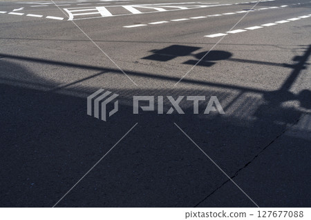A winter intersection where the shadow of a traffic light falls A winter intersection where the shadow of a traffic light falls 127677088