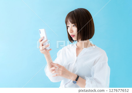A woman using a smartphone A woman using a smartphone 127677652
