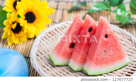 Summer tradition: cut watermelon and sunflowers Summer tradition: cut watermelon and sunflowers 127677727