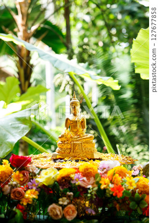 Buddha image and flowers. Preparation for Water Festival in Thailand. 127677858